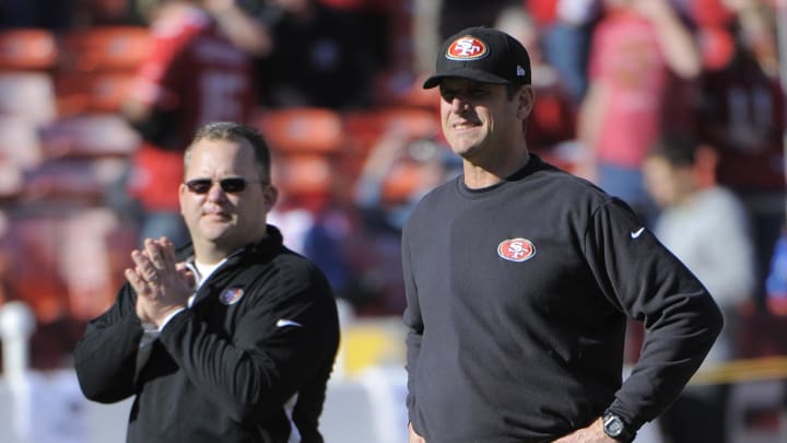 December 30, 2012; San Francisco, CA, USA; San Francisco 49ers head coach Jim Harbaugh (right) and offensive coordinator Greg Roman (left) watch warm ups before the game against the Arizona Cardinals at Candlestick Park. Mandatory Credit: Kyle Terada-USA TODAY Sports
