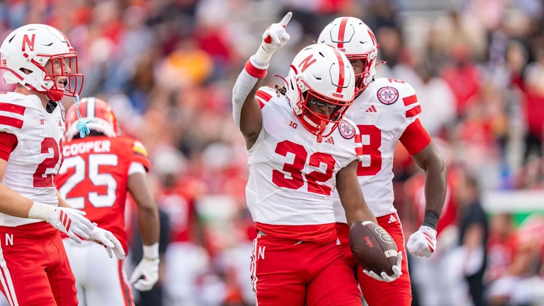 Kenneth Williams celebrates with teammates after his 85‑yard kickoff return during Nebraska’s win over Maryland.