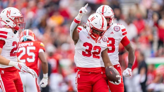 Kenneth Williams (32) celebrates with teammates after an 85-yard kickoff return in Nebraska’s win over Maryland.