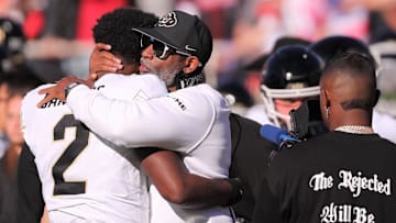 Colorado football coach Deion Sanders hugs his son, Shedeur Sanders, before facing Texas Tech.