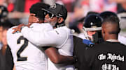 Colorado football coach Deion Sanders hugs his son, Shedeur Sanders, before facing Texas Tech in a Big 12 football game.