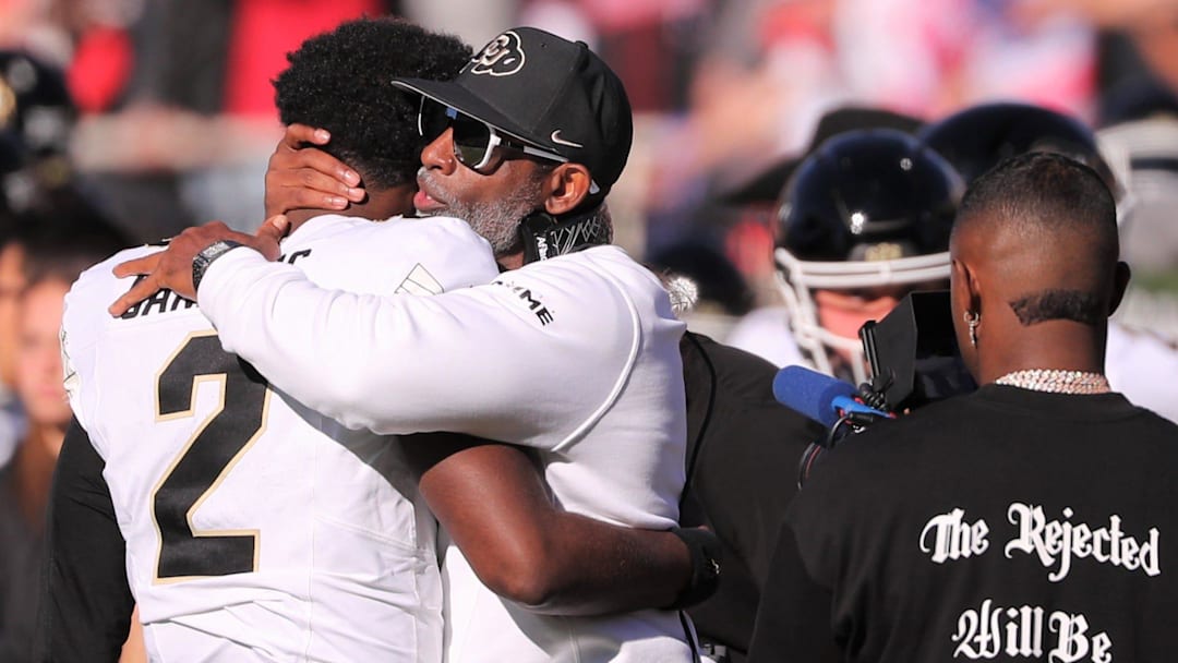 Colorado football coach Deion Sanders hugs his son, Shedeur Sanders, before facing Texas Tech in a Big 12 football game Saturday, Nov. 9, 2024, at Jones AT&T Stadium.