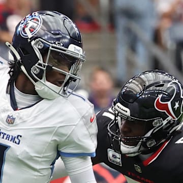 Tennessee Titans quarterback Cam Ward scrambles from Houston Texans defensive end Will Anderson Jr.