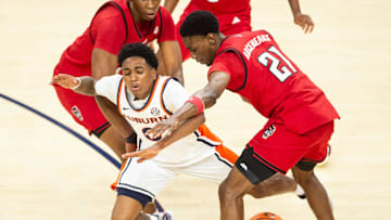 Auburn Tigers guard Tahaad Pettiford (0) draws a foul from NC State Wolfpack guard Terrance Arceneaux (21) as Auburn Tigers take on NC State Wolfpack at Neville Arena in Auburn, Ala. on Wednesday, Dec. 3, 2025. Auburn Tigers lead NC State Wolfpack 41-35 at halftime.