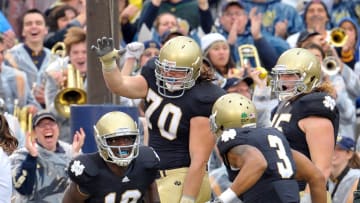 Notre Dame football wide receiver Duval Kamara (18) celebrates with Taylor Dever and teammates