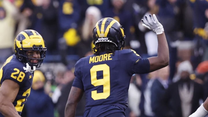 Nov 25, 2023; Ann Arbor, Michigan, USA; Michigan Wolverines defensive back Rod Moore (9) celebrates after he makes an interception in the second half against the Ohio State Buckeyes at Michigan Stadium. Mandatory Credit: Rick Osentoski-USA TODAY Sports