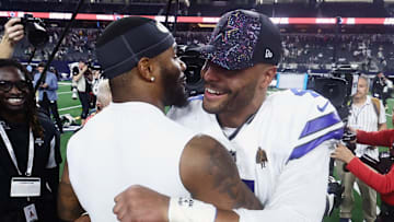 Sep 28, 2025; Arlington, Texas, USA; Dallas Cowboys quarterback Dak Prescott (4) and Green Bay Packers defensive end Micah Parsons (1) embrace after the game at AT&T Stadium. Mandatory Credit: Kevin Jairaj-Imagn Images