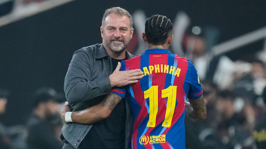 Hansi Flick (left) hugging Raphinha.