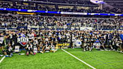 North Crowley coaches and players pose for a team shot following their victory in the Texas 6A Division 1 state championship game at AT&T Stadium.