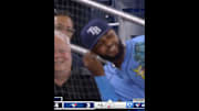 Junior Caminero untangles himself from the protective netting after chasing down a foul ball.