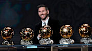 Lionel Messi with just some of the Ballons d’Or he has won.