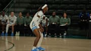 Tulane women's basketball player Kanija Daniel readies to play defense for the Green Wave