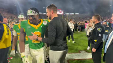 Oregon coach Dan Lanning consoles players after the loss to Ohio State at the Rose Bowl.
