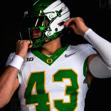 Luke Basso models Oregon Duck Football's uniforms for their game against the Iowa Hawkeyes.