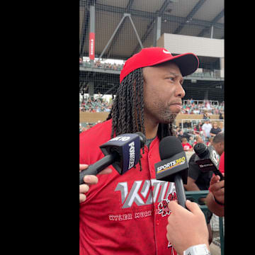 Larry Fitzgerald speaks with reporters.