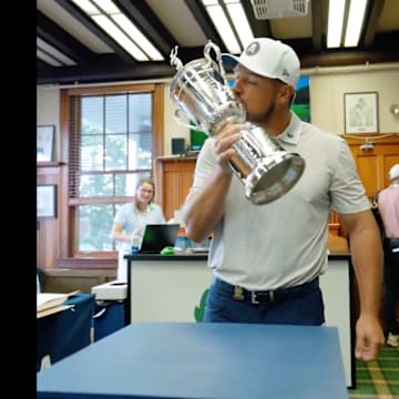 Bryson DeChambeau returns the U.S. Open trophy.
