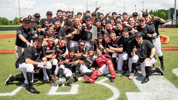 The Nebraska baseball team poses with the 2021 Big Ten Conference championship trophy.