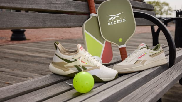 White and green Reebok pickleball shoes.