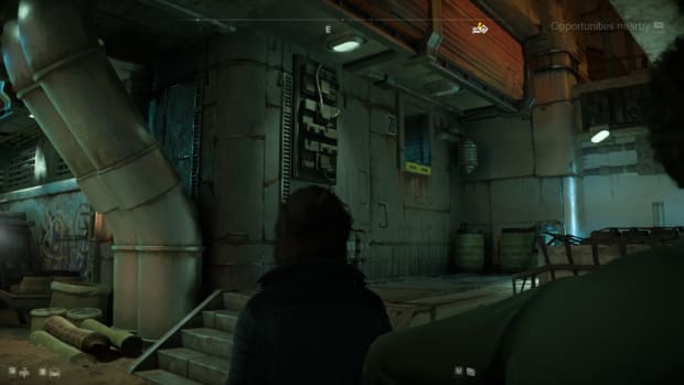 Star Wars Outlaws gameplay: Kay looking at an open vent in a small corner of a metallic town.