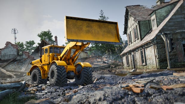 A yellow bulldozer against the backdrop of ruined houses.