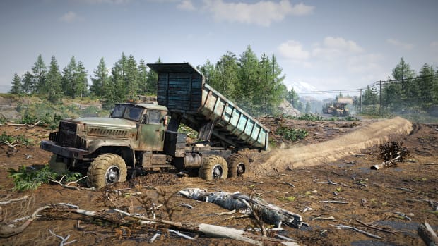 RoadCraft screenshot of a blue dump truck laying road foundation in a cleared forest area