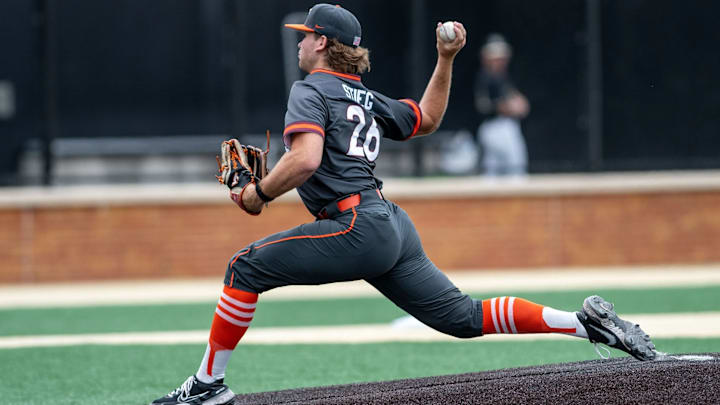 Griffin Stieg delivers the pitch in the gray Hokies jerseys.