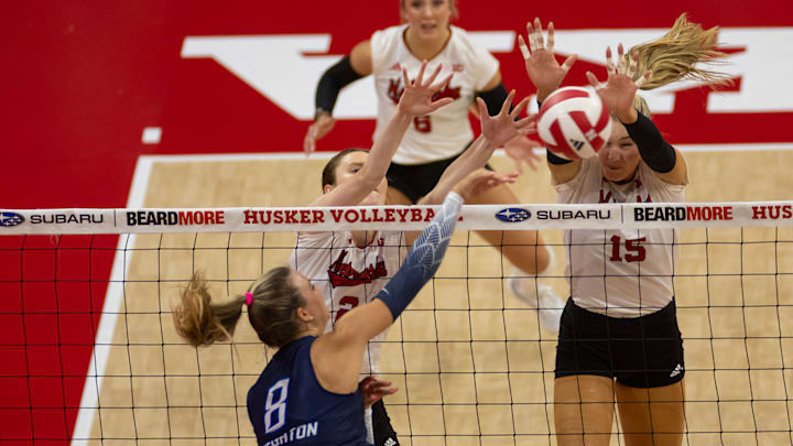 Nebraska's Bergen Reilly and Andi Jackson work to block a Creighton attack.