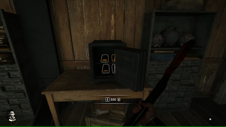 An open safe with gold bard inside.