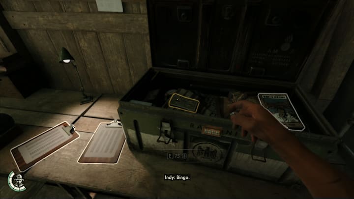 An open chest on a desk containing money and a book.