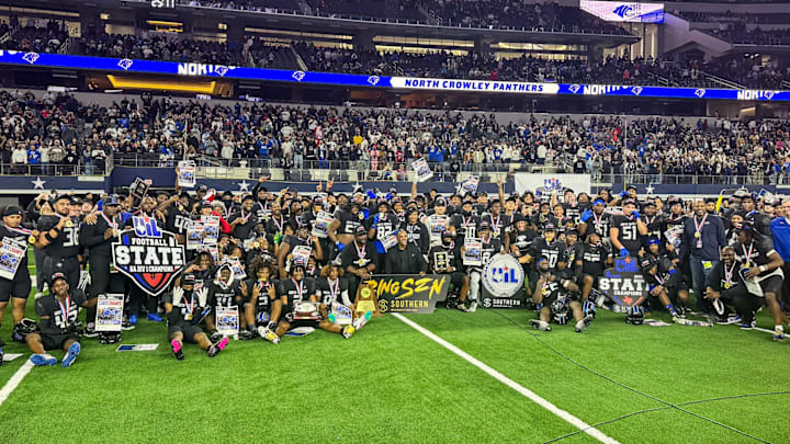 North Crowley coaches and players pose for a team shot following their victory in the Texas 6A Division 1 state championship game at AT&T Stadium.