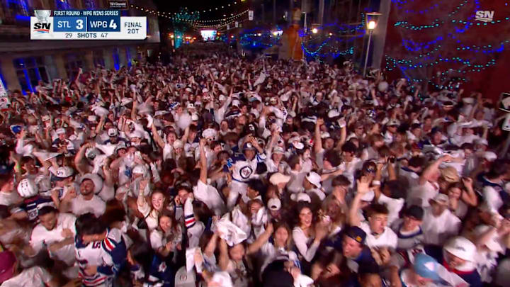 Winnipeg Jets fans celebrate the game-winning goal against the St. Louis Blues.