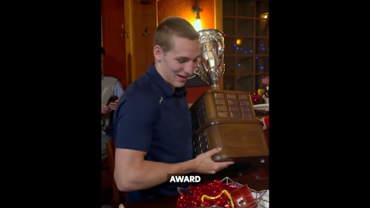 Lane Hutson receives the Calder Trophy after being named NHL rookie of the year.