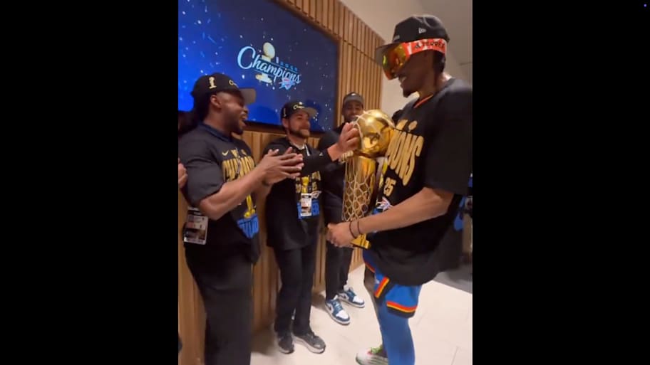 Jalen Williams takes the Larry O’Brien trophy on a celebration tour. | @NBA / X