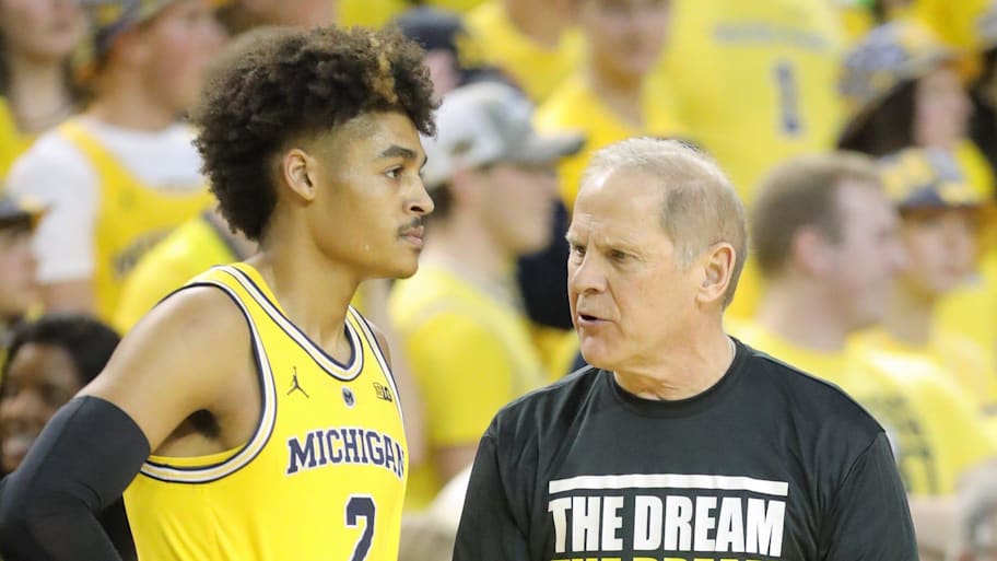 Michigan coach John Beilein talks with guard Jordan Poole during a game against Minnesota,