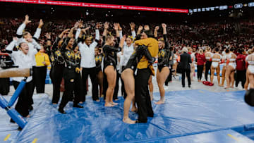 March 14, 2025; Arkansas, United States; Helen Hu hugs her coach as her teammates hold up 10 fingers to celebrate her routine. Mandatory Credit: Riley Hogan, Mizzou Athletics