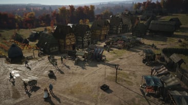 Manor Lords screenshot showing a developed town's marketplace.