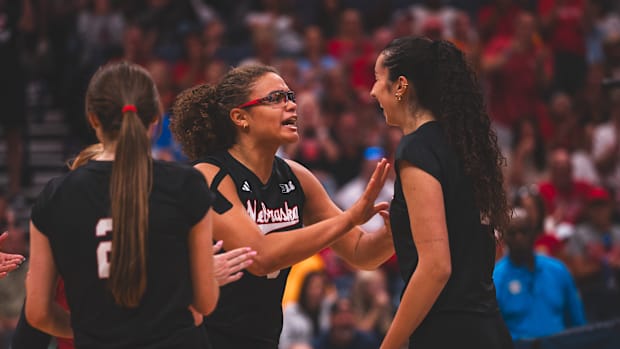 Nebraska middle blocker Rebekah Allick and opposite hitter Virginia Adriano celebrate.