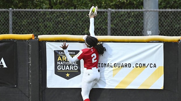 Orange Lutheran (Calif.) center fielder Kai Minor robs a Pacifica batter of a home run with a stellar catch during the CIF Southern Section Division 1 softball championship game at Deanna Manning Stadium in Irvine.