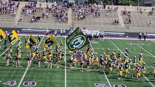 St. Edward players run onto the field prior to a game against Elder on September 14, 2024. 