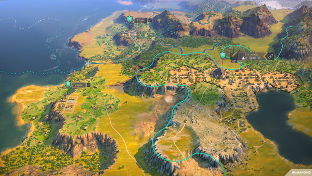 Humankind screenshot showing a lush landscape with a walled town.
