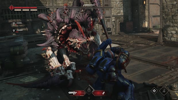 Warhammer 40,000: Space Marine 2 screenshot of a Space Marine holding off a giant monster with bare hands.