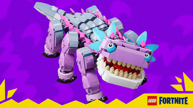 LEGO Fortnite screenshot of Klombo, a pink six-legged dinosaur made of blue accents on the eyes and feathers on its head.