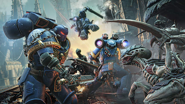 Warhammer 40,000: Space Marine 2 screenshot of Space Marines fighting insectoid Tyranids.