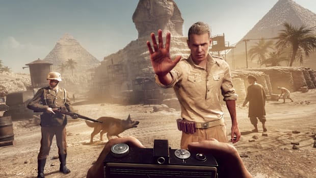 A man in uniform makes a gesture to stop you from taking photos around the pyramids.