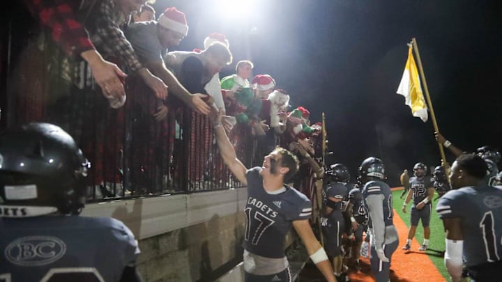 Benedictine quarterback Luke Kromenhoek celebrates with fans in the student section following Friday night's win over North Oconee.