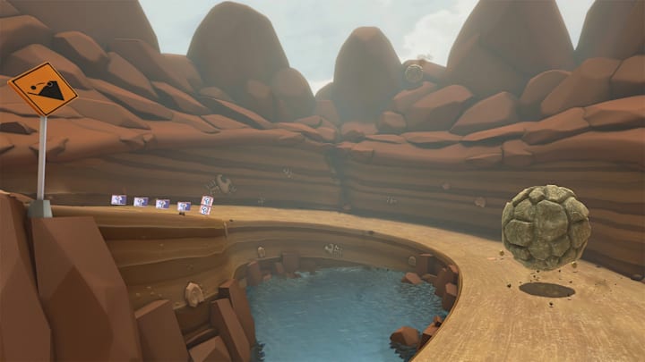 A chocolate-coloured mountain with a racetrack going through it as boulders fall from the cliffs.