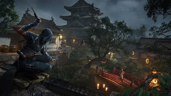 Naoe perched on a castle wall getting ready to throw a knife at someone on a bridge.