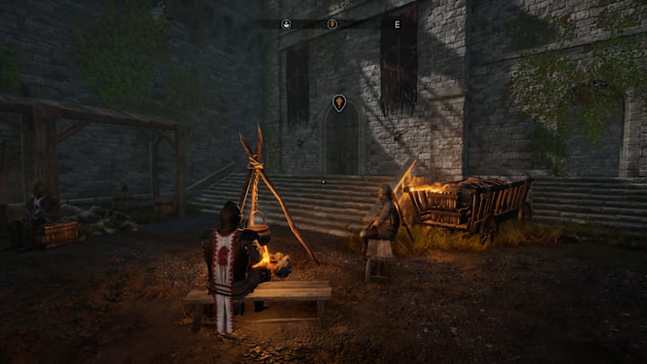A fortress with medieval knights sitting around a campfire in the courtyard.