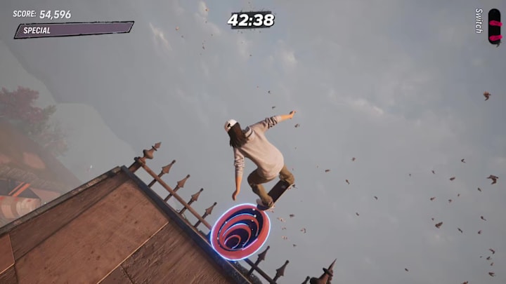 The player skating up the side of a building to collect an Iron Galaxy logo in the Suburbia level in THPS 3+4