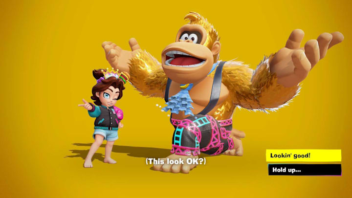 Donkey Kong with golden fur posing on one knee next to Pauline who is wearing a pink, black, and cyan bomber jacket.